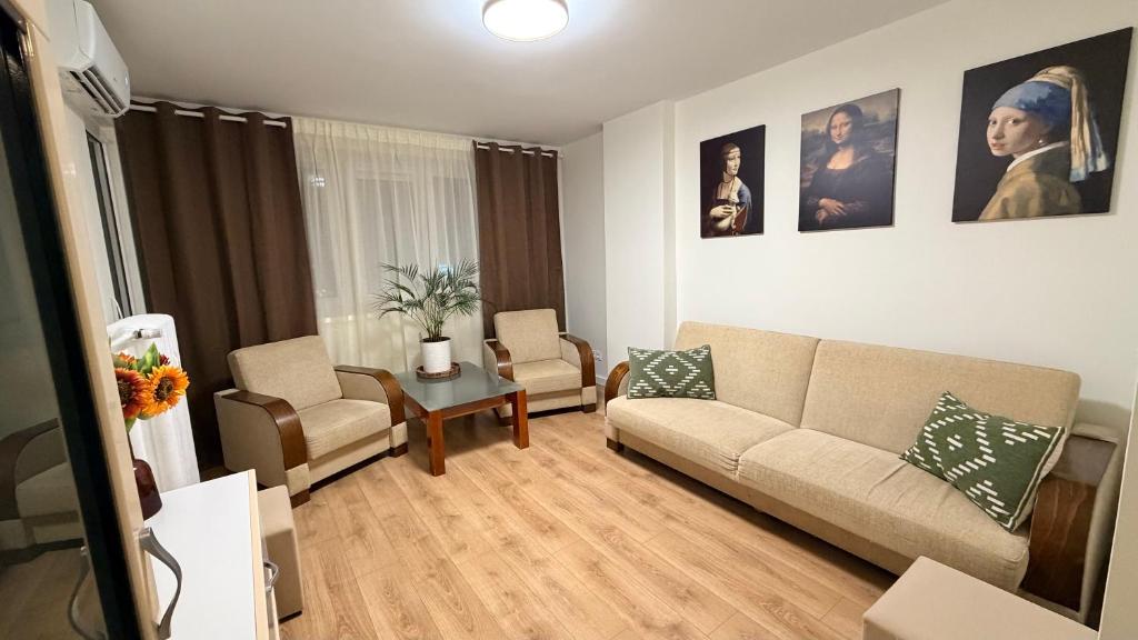 a living room with a couch and two chairs at Studio 13 Warsaw in Warsaw