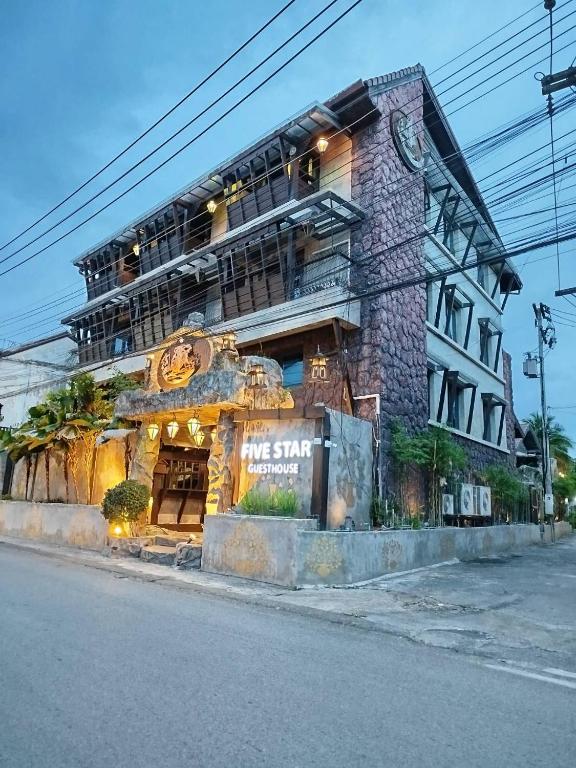 a building on the side of a street at Five Star Guest house in Chiang Mai
