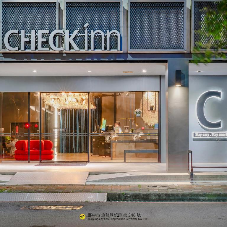 a store front with a red couch in the window at CHECK inn Taichung Liming in Taichung