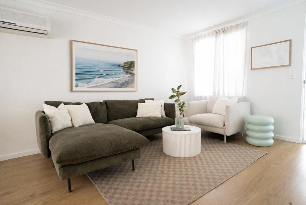 a living room with a couch and a chair at Blueholes Beach Villa - Private Outdoor Space in Kalbarri