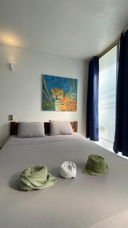 a bedroom with a bed with two pillows on it at Amazonas magic in Leticia