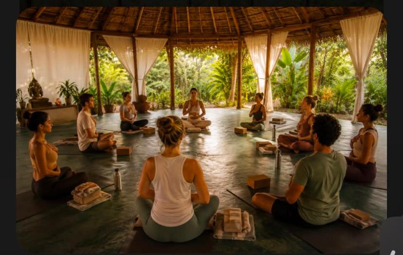 a group of people sitting in a yoga class at Goa Yoga Retreat in Mandrem