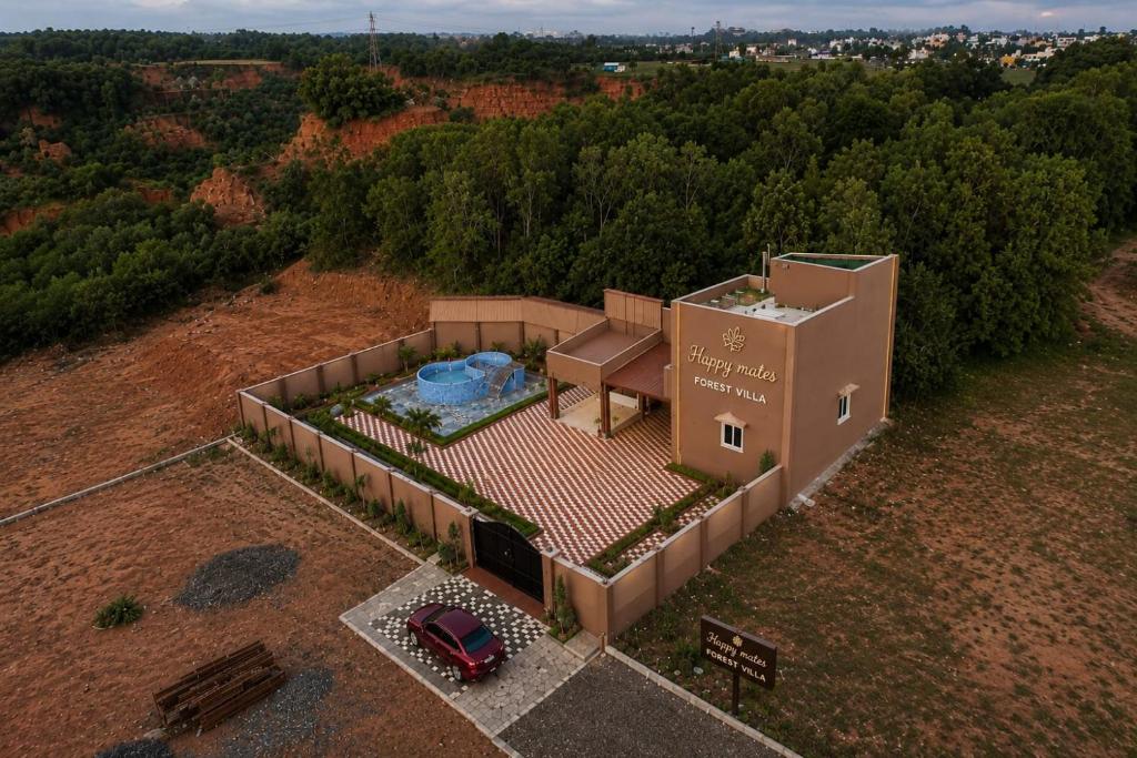 an overhead view of a house with a car in front at Happy Mates Forest Villa in Pondicherry