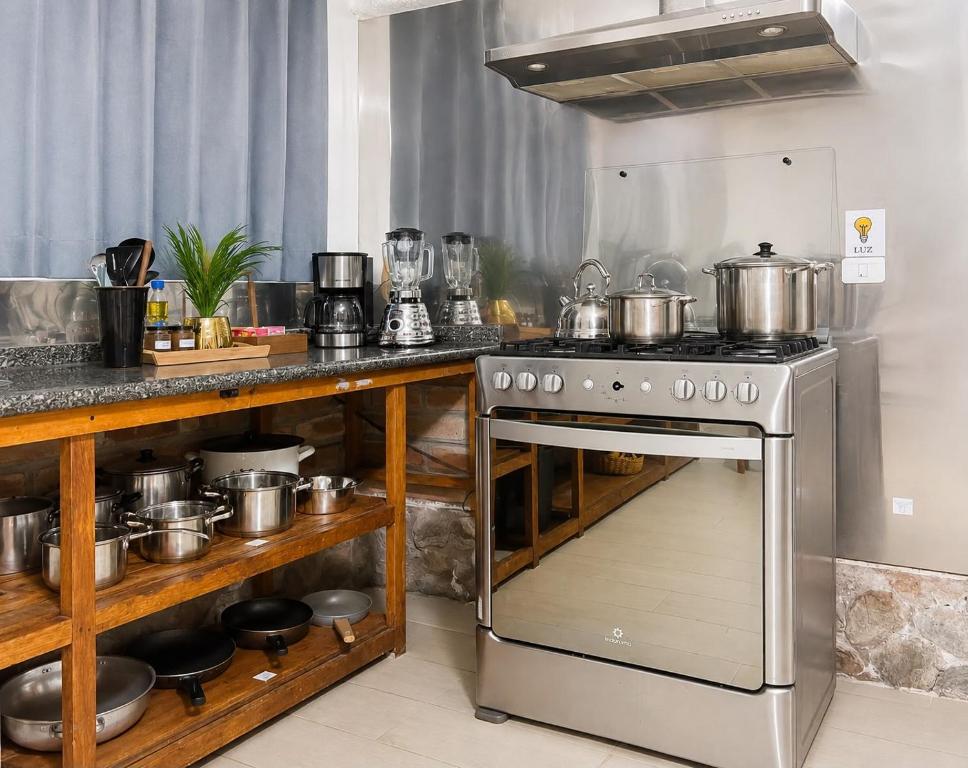 a kitchen with a stove and some pots and pans at Riverside Estate with Jacuzzi 9 Bedroom 7 Bath in Baños