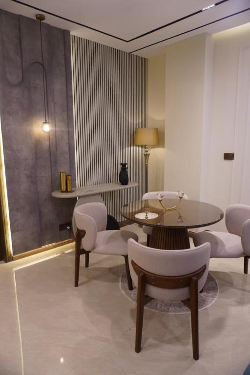 a living room with a table and chairs and a table and chairs at Emanzara in Islamabad
