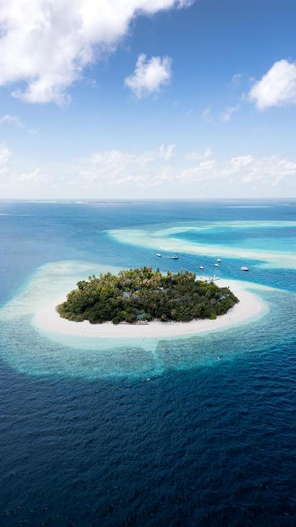 an island in the middle of the ocean at Malahini Kuda Bandos Special Offer Begin your island escape with ease airport pick up and return by shared speedboat at just USD 50 per person stays stay untill end October 2026 in North Male Atoll