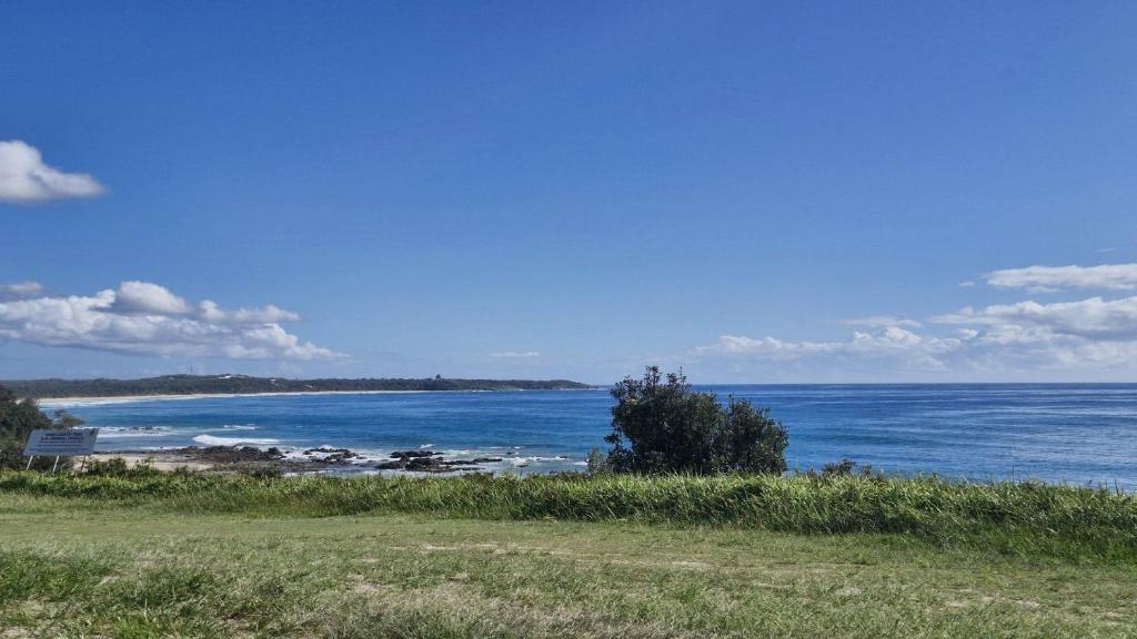a view of a beach with the ocean at Beachside Bungalow in Minnie Water