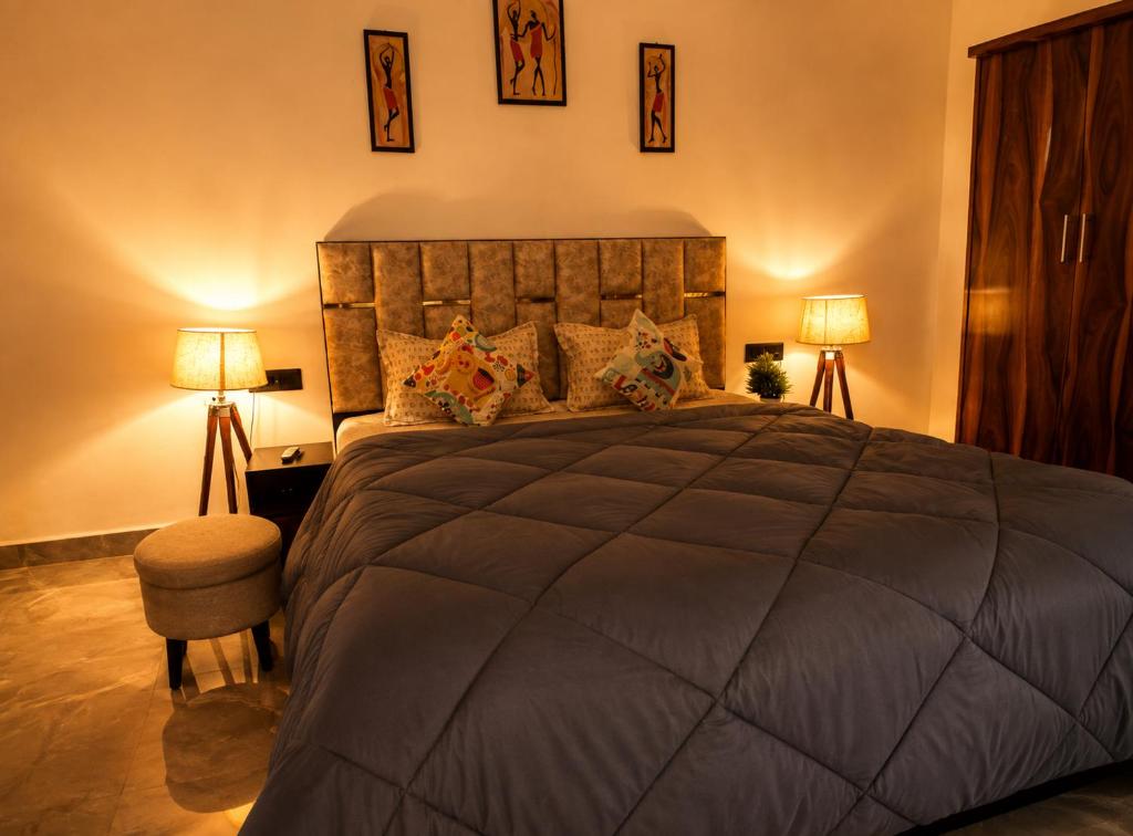 a bedroom with a large bed with two lamps at Cozy and Tranquil nest with wifi and homely care in Greater Noida