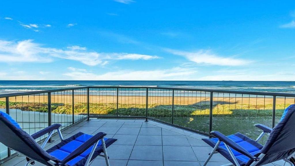a balcony with chairs and a view of the ocean at The Peninsula Wooli in Wooli