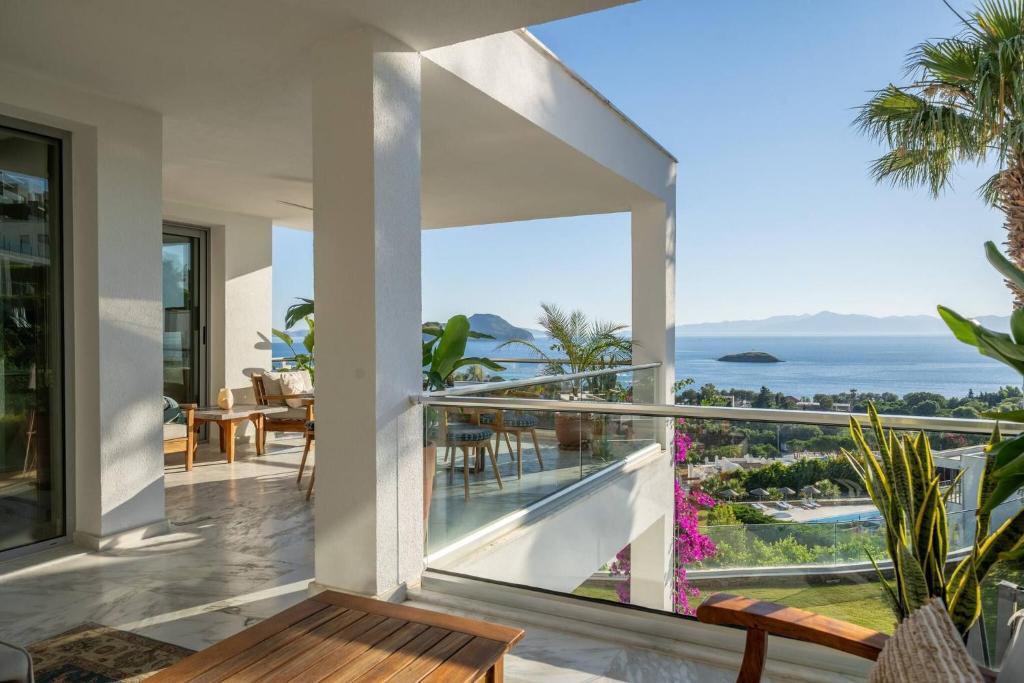 a view of the ocean from the balcony of a house at Villa Matie Bodrum Views in Bodrum City