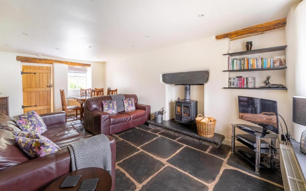 a living room with a couch and a fireplace at 2 Bed in Ambleside oc-lr059 in Ambleside
