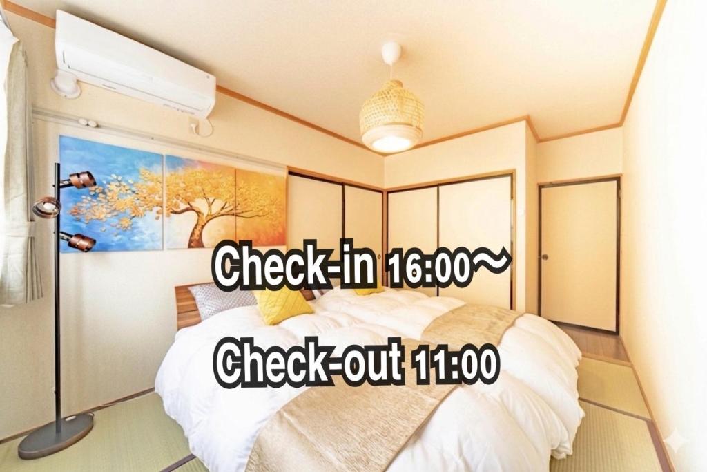 a bedroom with a bed in a room at Coucou! in Takasaki
