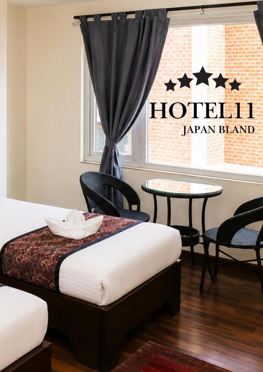 a room with two beds and a table and chairs at Apartment Hotel 11 Thamel in Kathmandu