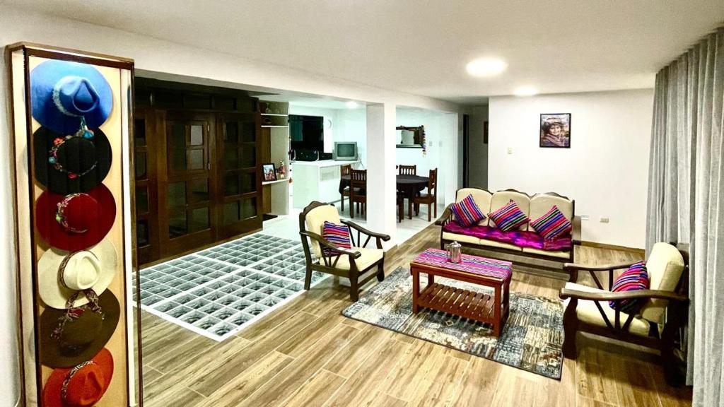 a living room with a couch and chairs and a table at Morada del Huascarán in Mancos
