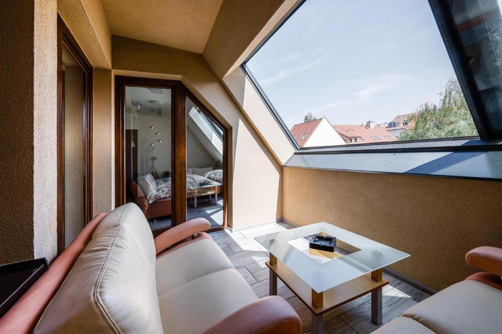 a room with a couch and a table and a window at Jarkova panorama view in Prešov