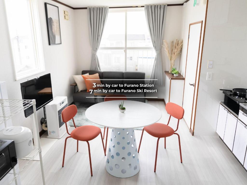 a small living room with a table and chairs at Lavender Breeze Furano 2 in Furano