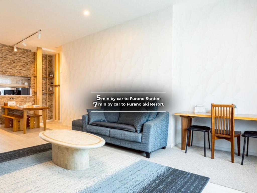 a living room with a couch and a table at furano ski rabi in Furano
