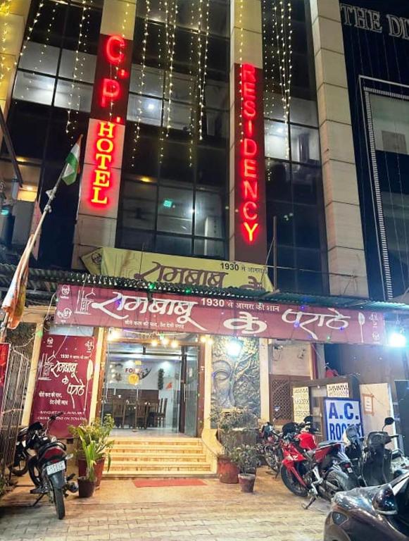 a building with motorcycles parked in front of it at Hotel CP Residency in Agra