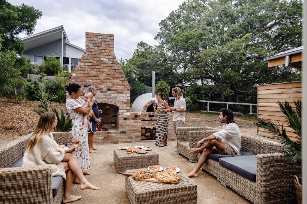 a group of people standing around in a yard at Eagles Nest Milton in Milton