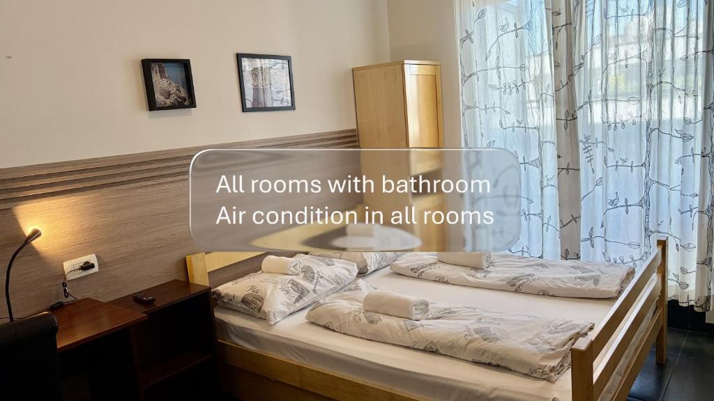 two beds in a room with the words all rooms with bedroom art condition in all at Hostel Moving in Zagreb
