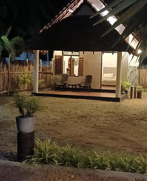 a pavilion with a bed and a couch in a yard at Kite Brothers Resort in Kalpitiya