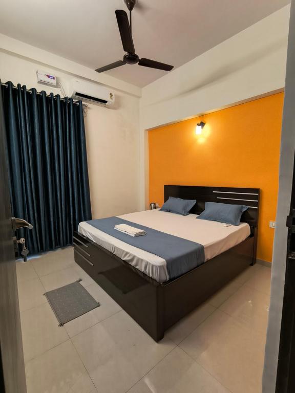 a bedroom with a large bed with a black frame at The Global Nest Homestay 