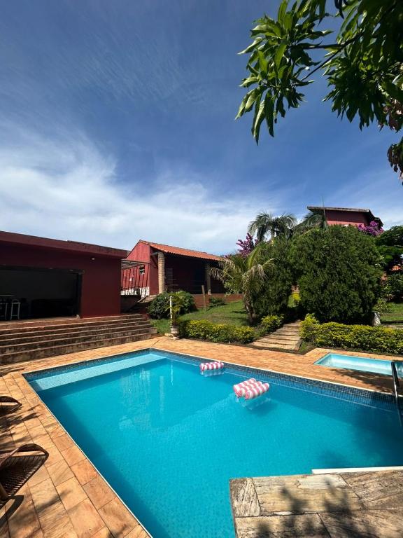 a swimming pool in front of a house at Casa com piscina - itupeva in Itupeva