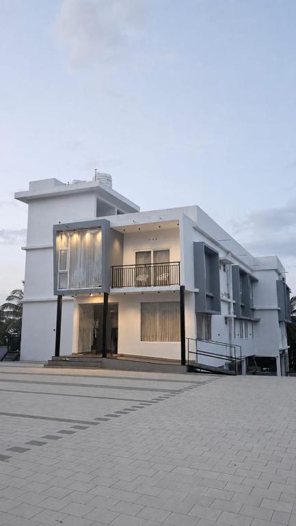 a large white building with a lot of windows at Grace Residency in Sultan Bathery