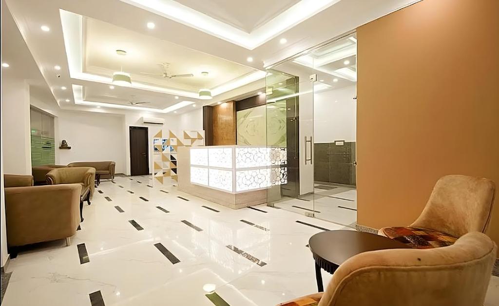 a lobby with couches and chairs in a room at Hotel Apple Park - Near Delhi Airport, Free Airport Trasnfer in New Delhi
