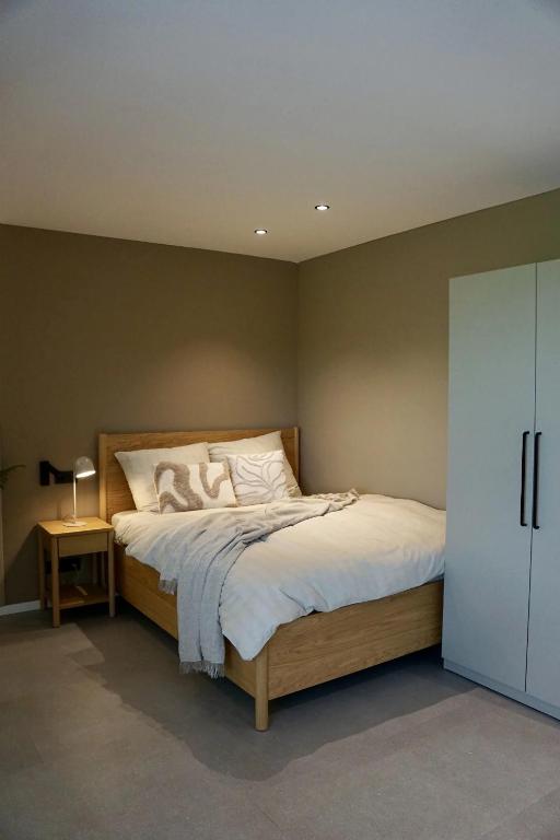 a bedroom with a large bed with white pillows at SmartStay in Gronau