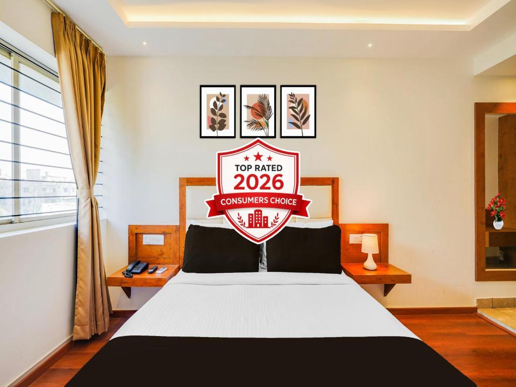 a bedroom with a bed with a sign on it at Super Townhouse Ramamurthy Nagar West Formerly Phoenix Hotel in Bangalore