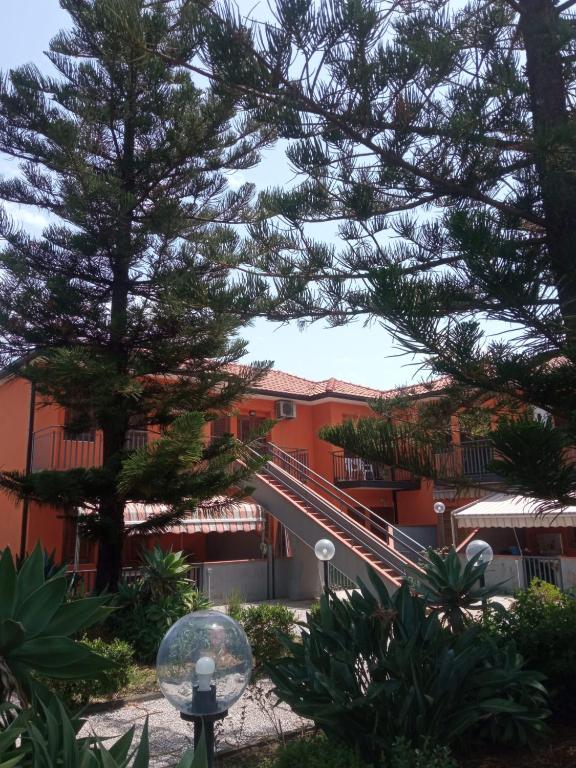 a building with a staircase in front of it at Casa Le Araucarie in Mascali