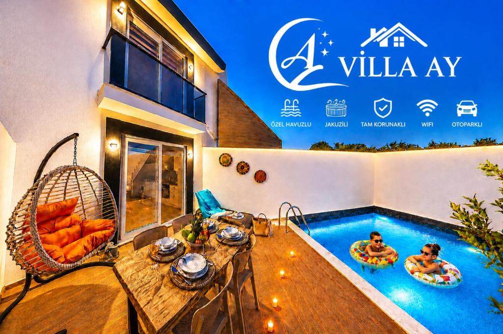 a villa with a swimming pool and a table and chairs at Villa Ay in Kaş