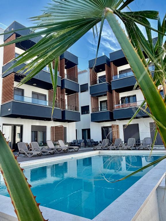 a resort with a swimming pool and a building at Slatine Residence Apartament No 1 in Slatine