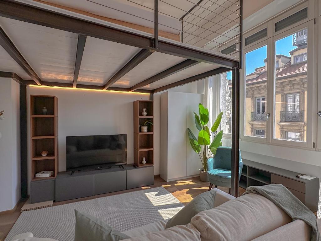 a living room with a couch and a tv at FLATSHARING - SPADARI Duomo Suites in Milan