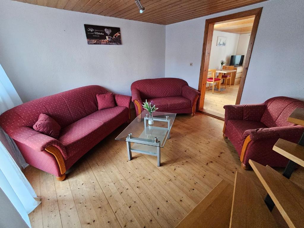 a living room with two couches and a table at Hofruhe in Neresheim