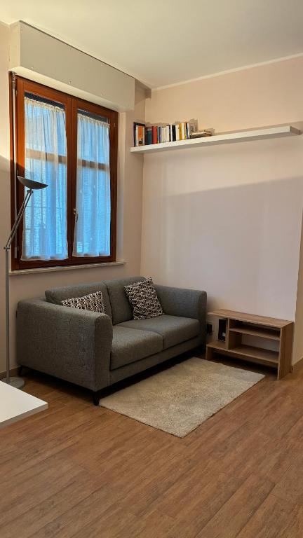 a living room with a couch and a window at Il Glicine in Cusano Milanino
