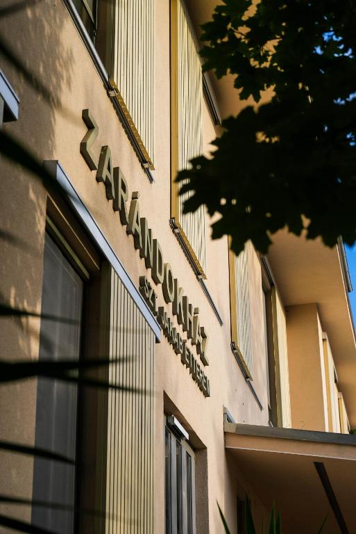 a building with a sign on the side of it at Mátraverebély-Szentkút Nemzeti Kegyhely in Mátraverebély