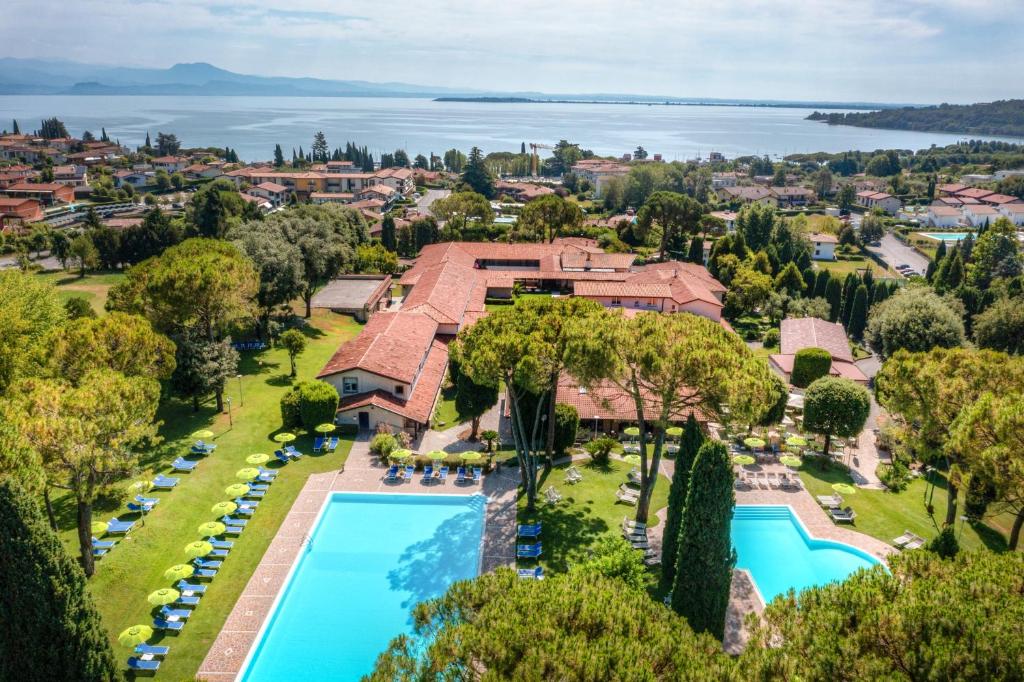 an aerial view of a mansion with a swimming pool at West Garda Hotel in Padenghe sul Garda
