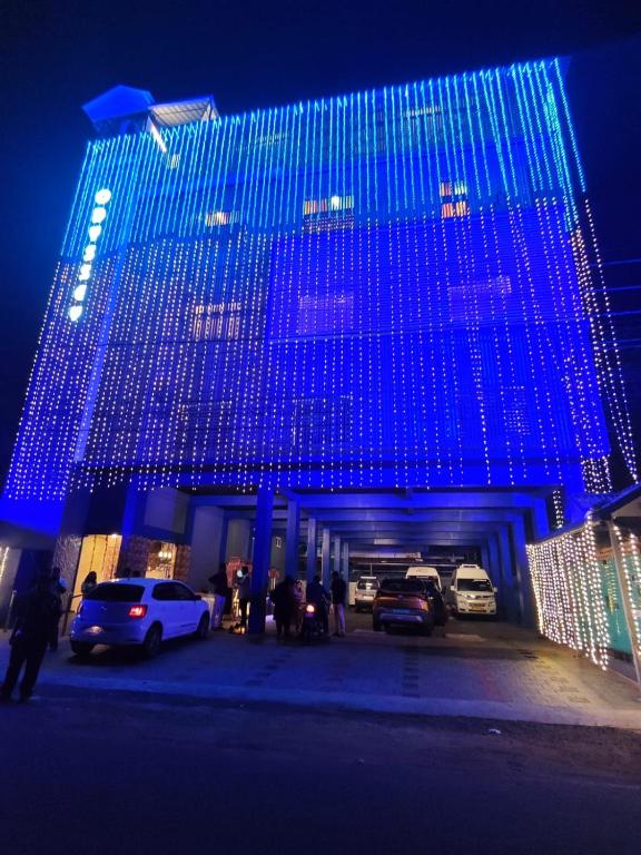 a blue building with cars parked in front of it at Odyssey Rendezvous in Chottanikara