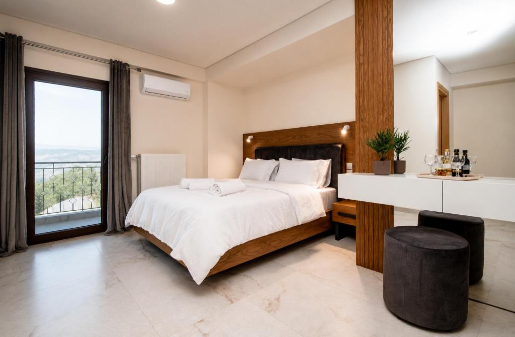 a bedroom with a large bed and a large window at Ligiades 945 in Ligiades