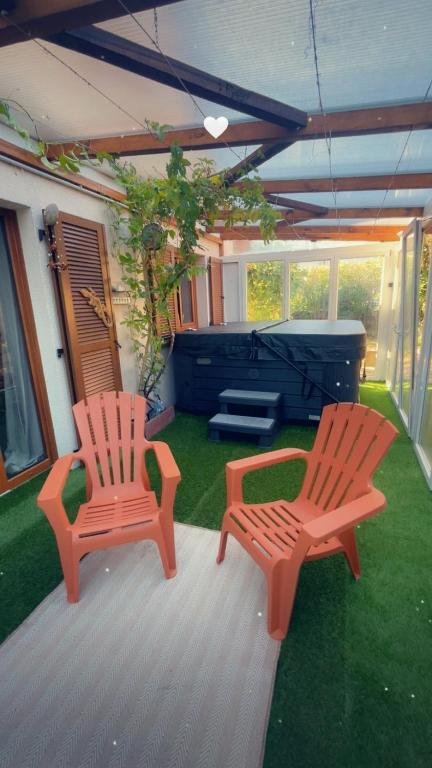 two chairs sitting on a patio with a stage at La Belle au Bois Joli in Raon-lʼÉtape
