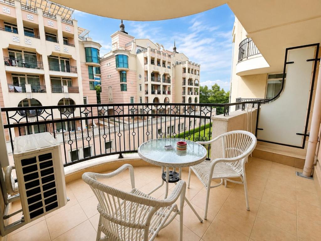 a balcony with a table and chairs on a balcony at Красавиците тъмнокоси Sunset Family in Pomorie