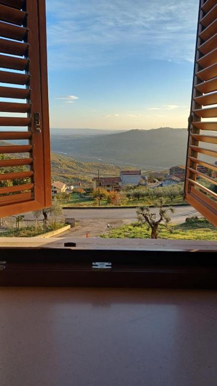 a window with a view of a view of a field at A casa di Meggie in Dogliola