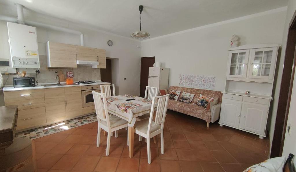 a kitchen with a table and chairs and a couch at Dimora Frasassi - Genga in Genga