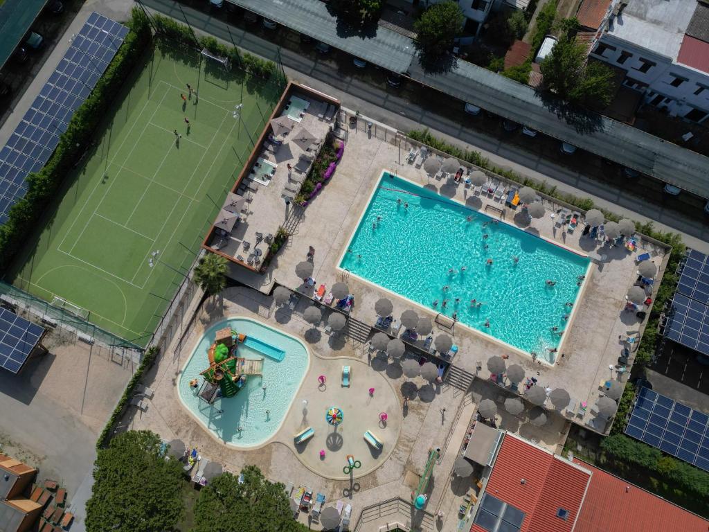 an overhead view of two swimming pools and a tennis court at Park Gallanti in Lido di Pomposa