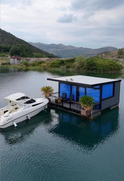 a boat is docked next to a house on the water at Dream house in Rragam