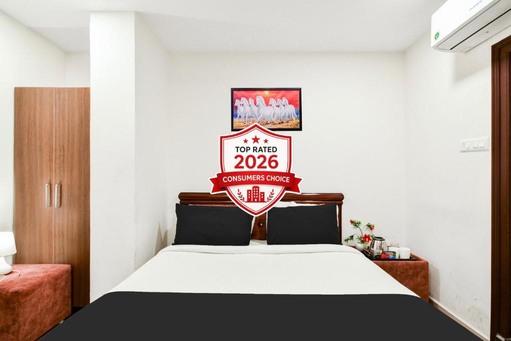 a bedroom with a bed with a sign that reads at Super Collection O Madhapur in Hyderabad