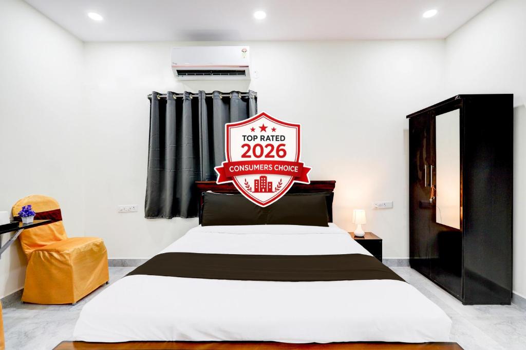 a bedroom with a bed with a football crest on it at Super Collection O Vanasthalipuram in Hyderabad