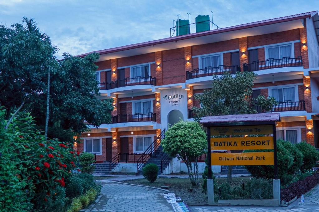 a building with a sign in front of it at Batika Resort Sauraha in Sauraha